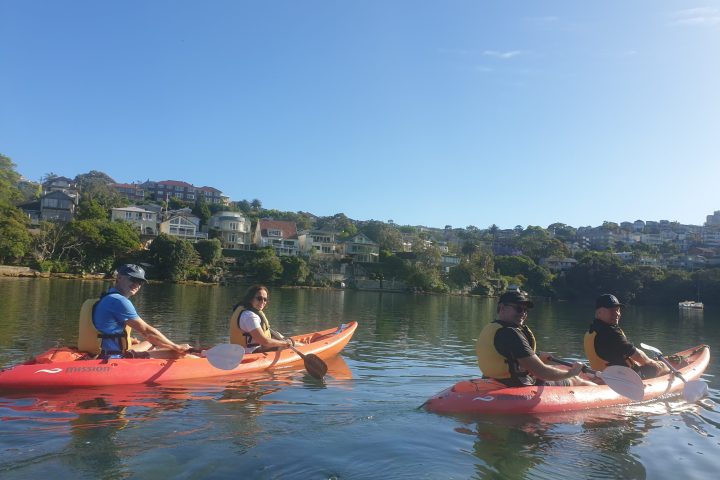 a group of people rowing a boat in the water