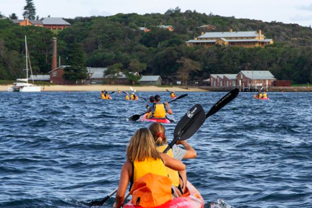 a man riding on the back of a boat in a body of water