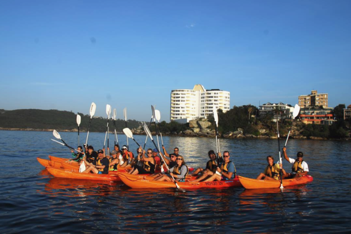 a group of people in a small boat in a body of water