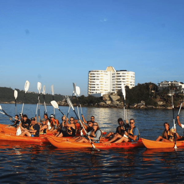 a group of people in a small boat in a body of water
