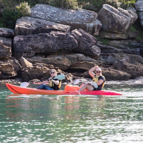 a man riding on the back of a boat in the water
