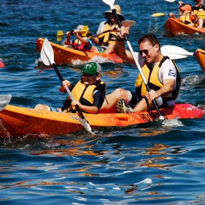 People paddling on the beach