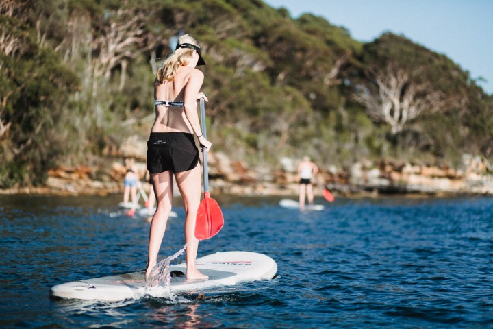 Girl doing SUP on the beach