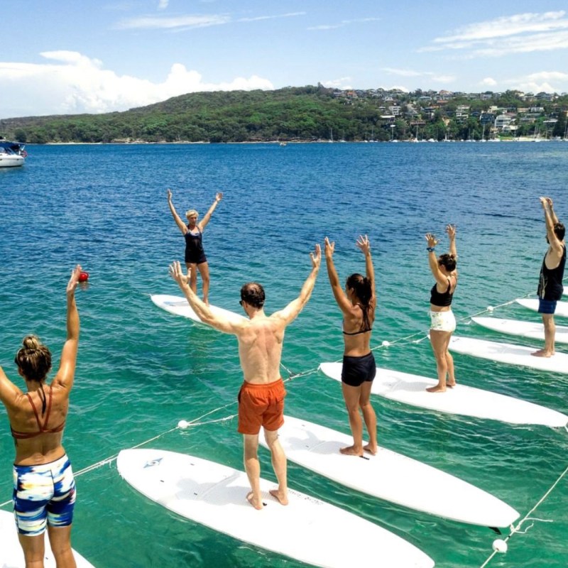 a group of people standing next to a body of water