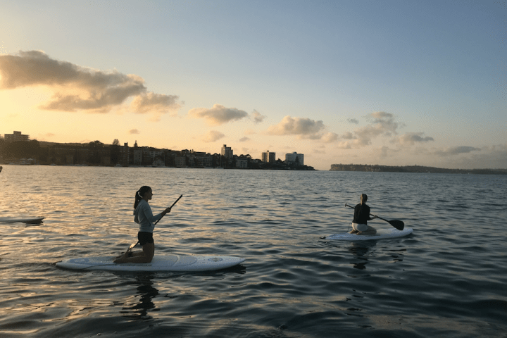 a man riding on the back of a boat in a body of water