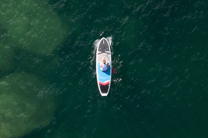 a person riding a surf board on a body of water