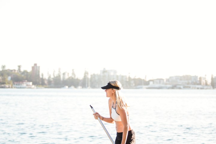 a man standing next to a body of water