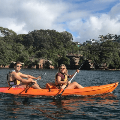 a group of people riding on the back of a boat in the water