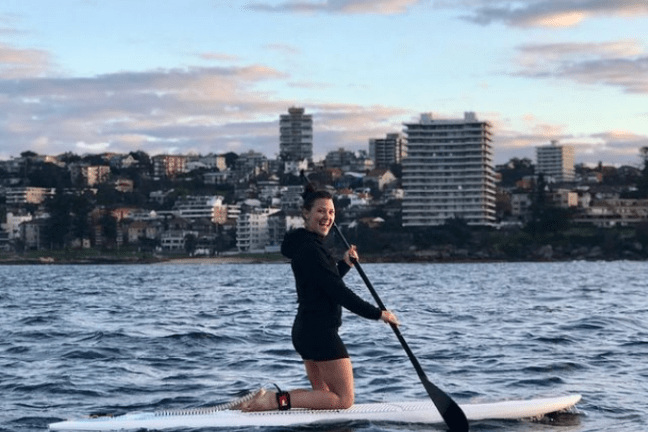 a person riding a surf board on a body of water