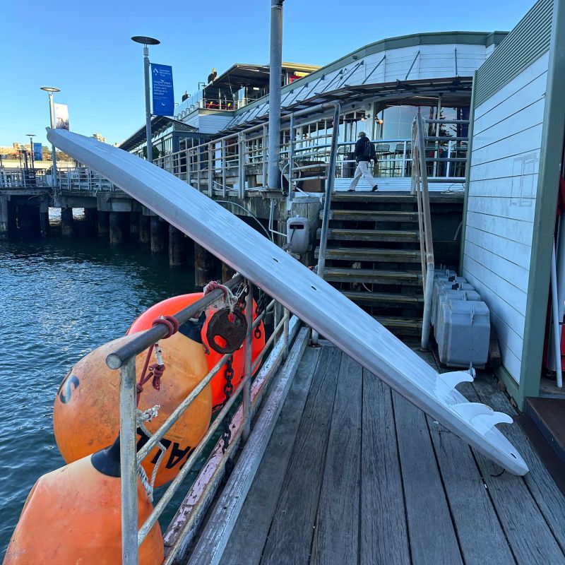 a boat sitting on top of a wooden fence
