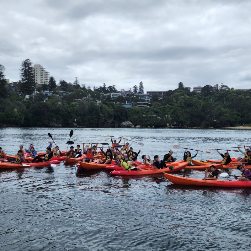 a group of people in a boat on a body of water