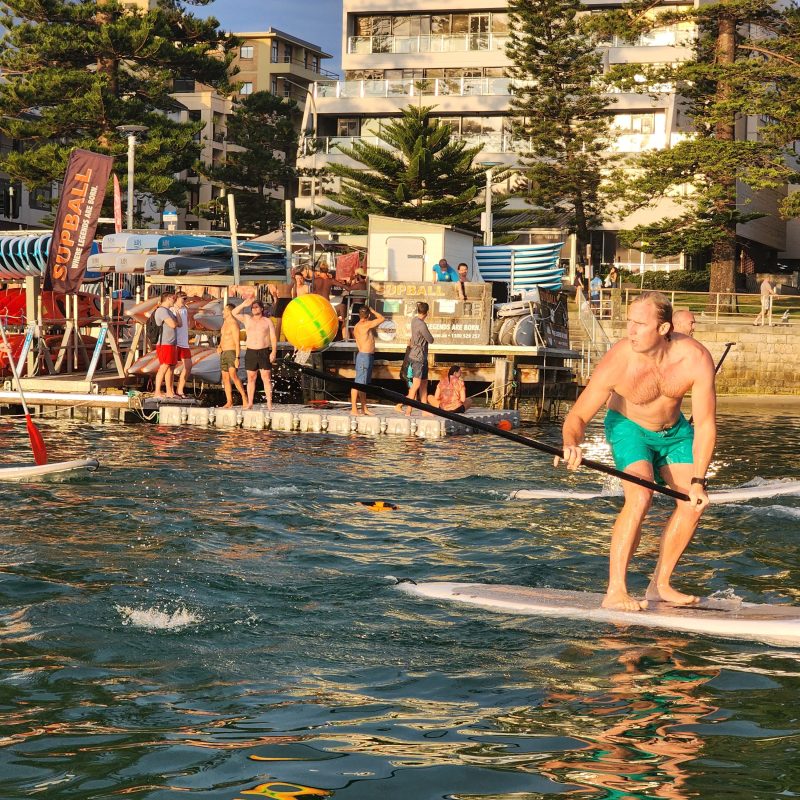 a young girl riding a wave on a surfboard in the water