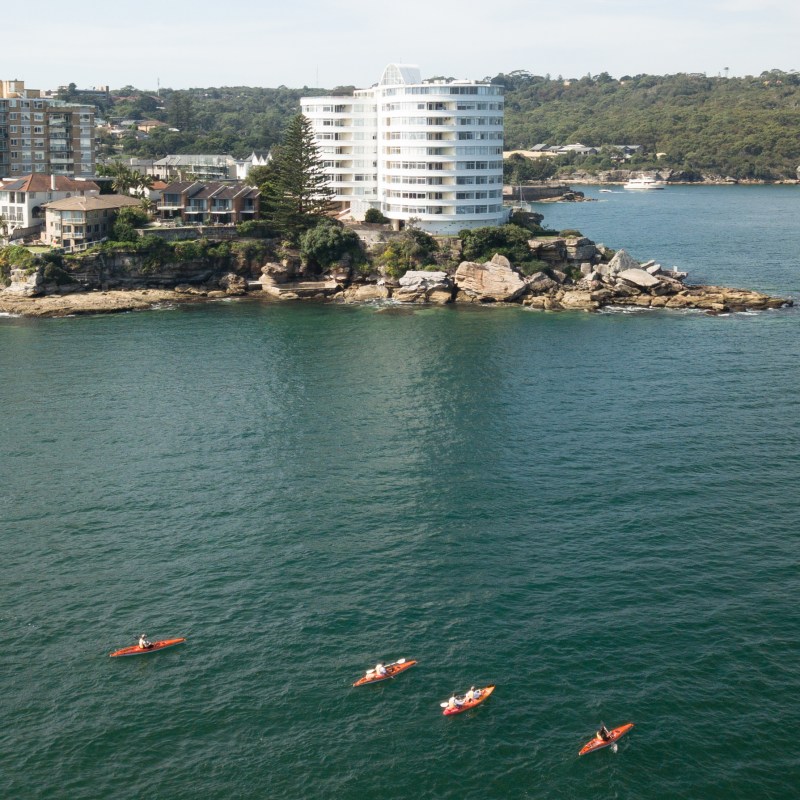 a large body of water with a city in the background