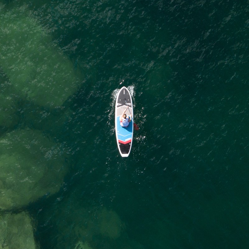 a person riding a surf board on a body of water