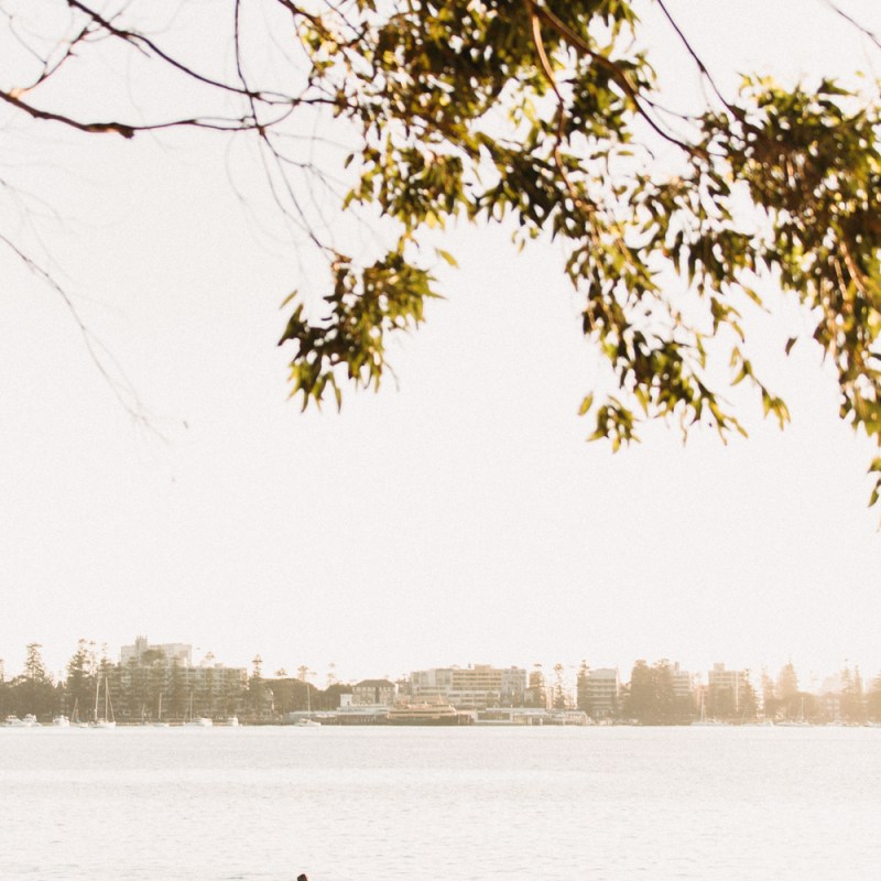 a group of people standing next to a body of water