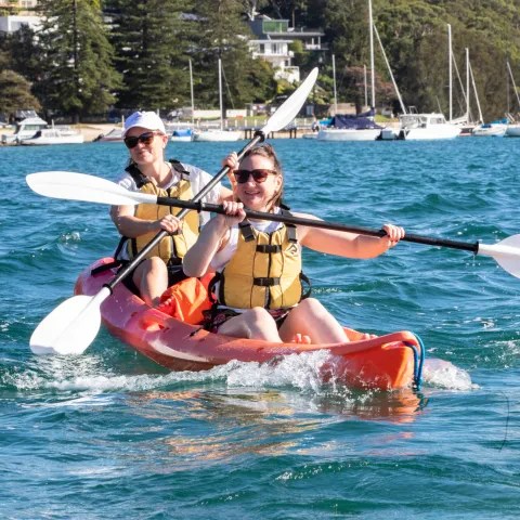a man riding on the back of a boat in the water