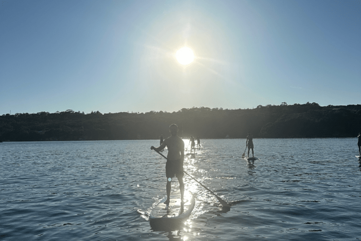 a man standing next to a body of water