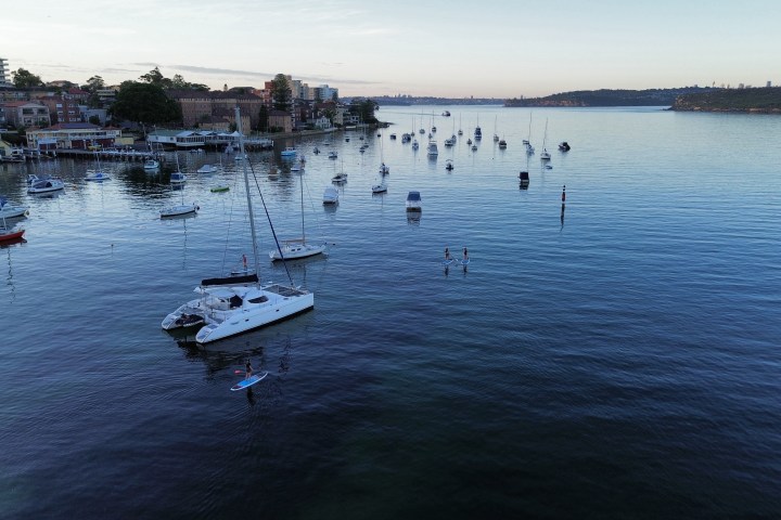 a small boat in a harbor next to a body of water